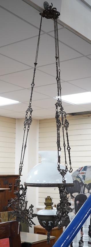 A French barn iron and white glass hanging lamp, approximately 140cm high. Condition - used, iron work needs cleaning